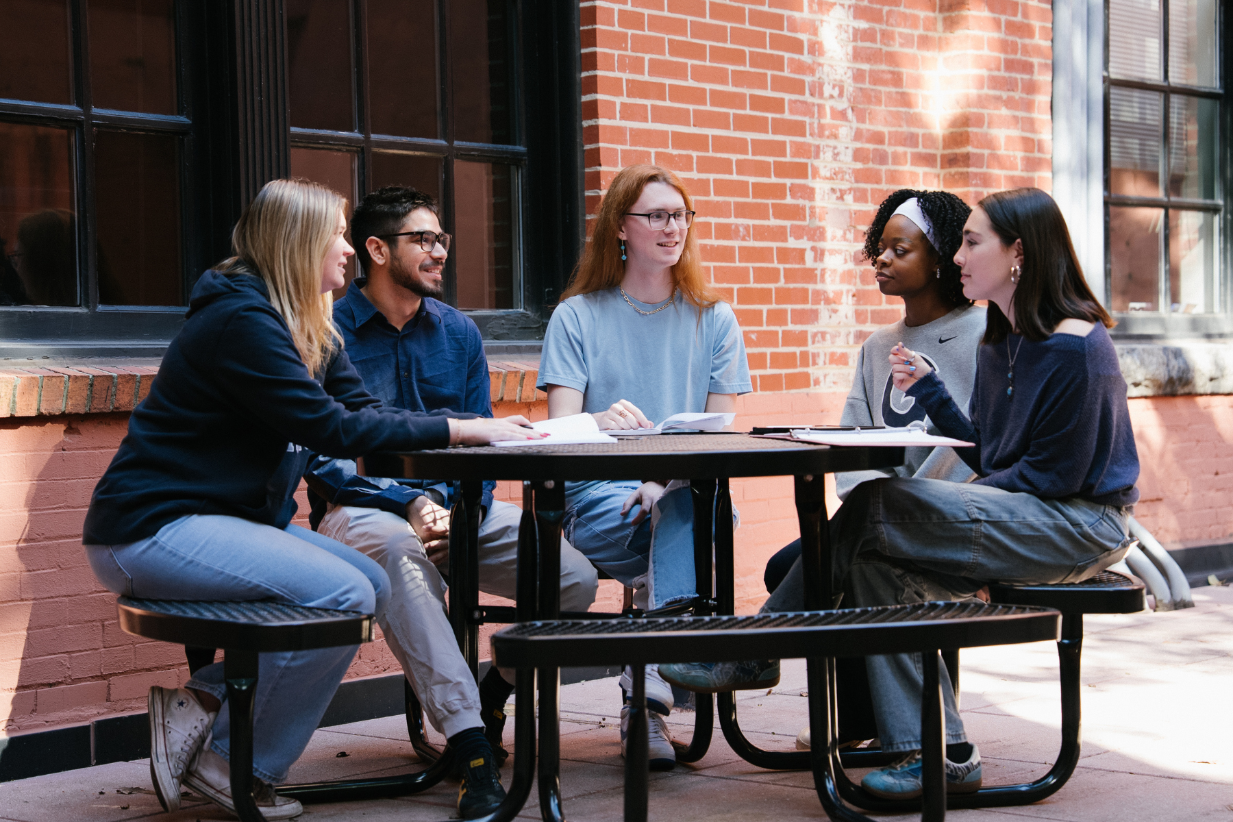 DSAN students chat at a table in our courtyard